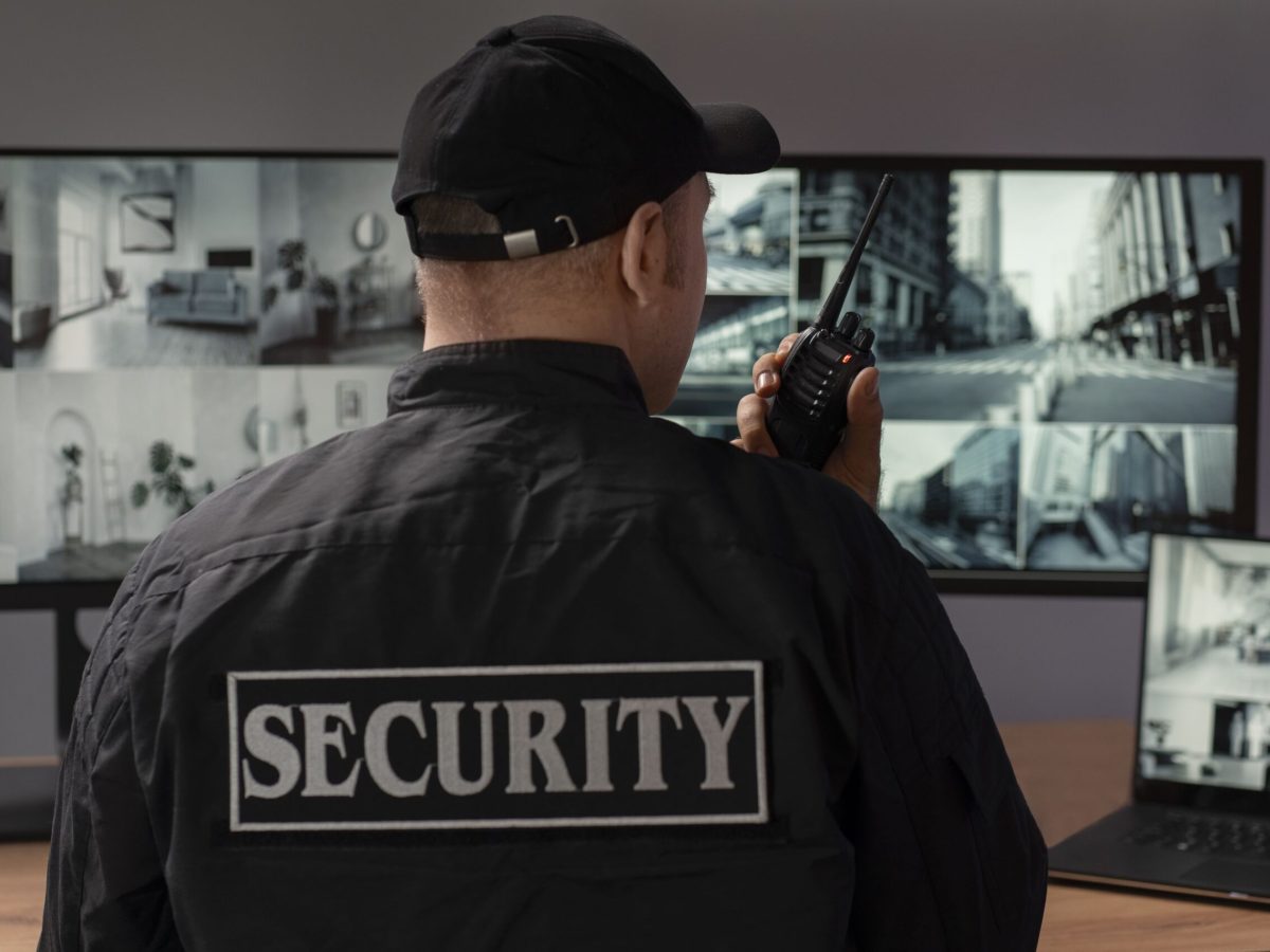 portrait-male-security-guard-with-radio-station-camera-screens (1)